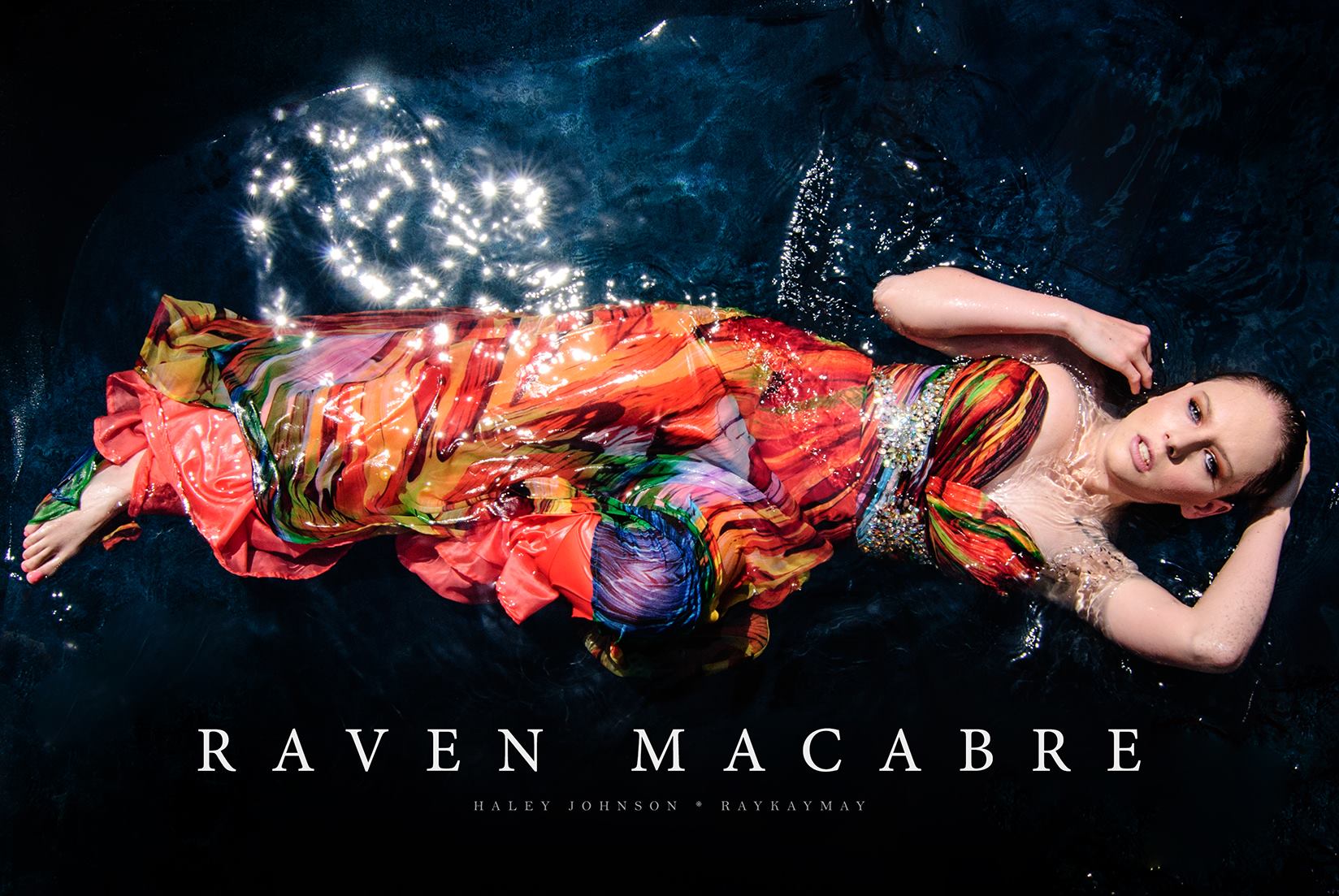 Woman floating in dark blue water wearing a vivid colorful dress