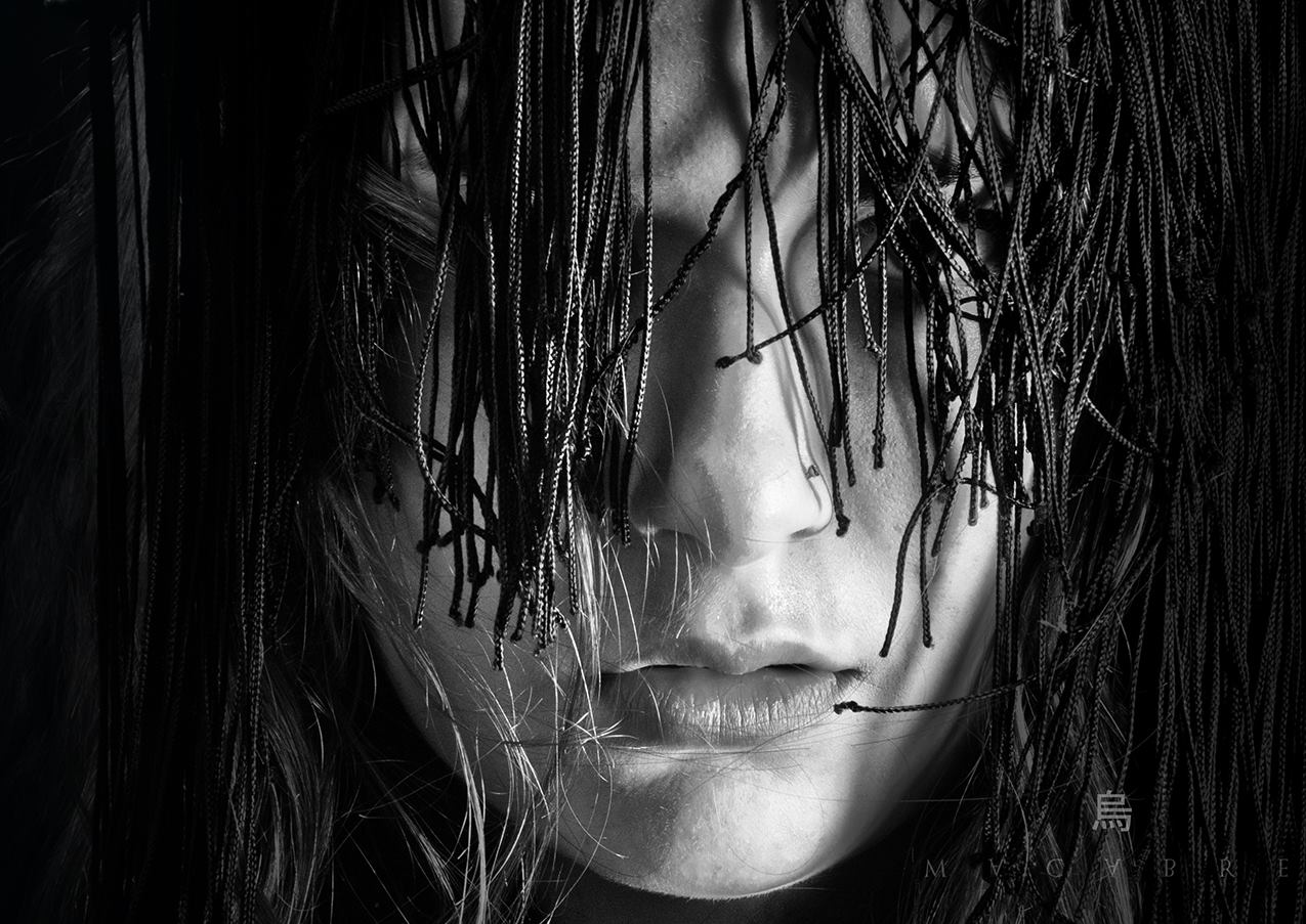 Black and white close-up portrait behind fringe